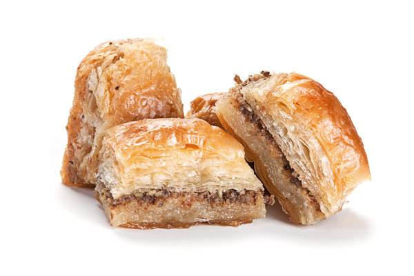 Three pieces of baklava with flaky layers and nut filling.